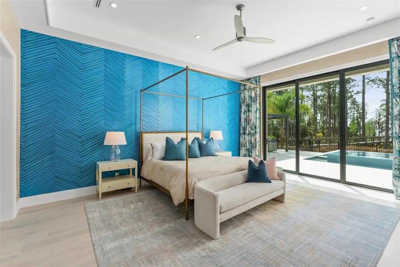 Suíte máster com cama de dossel e portas de vidro para a área da piscina